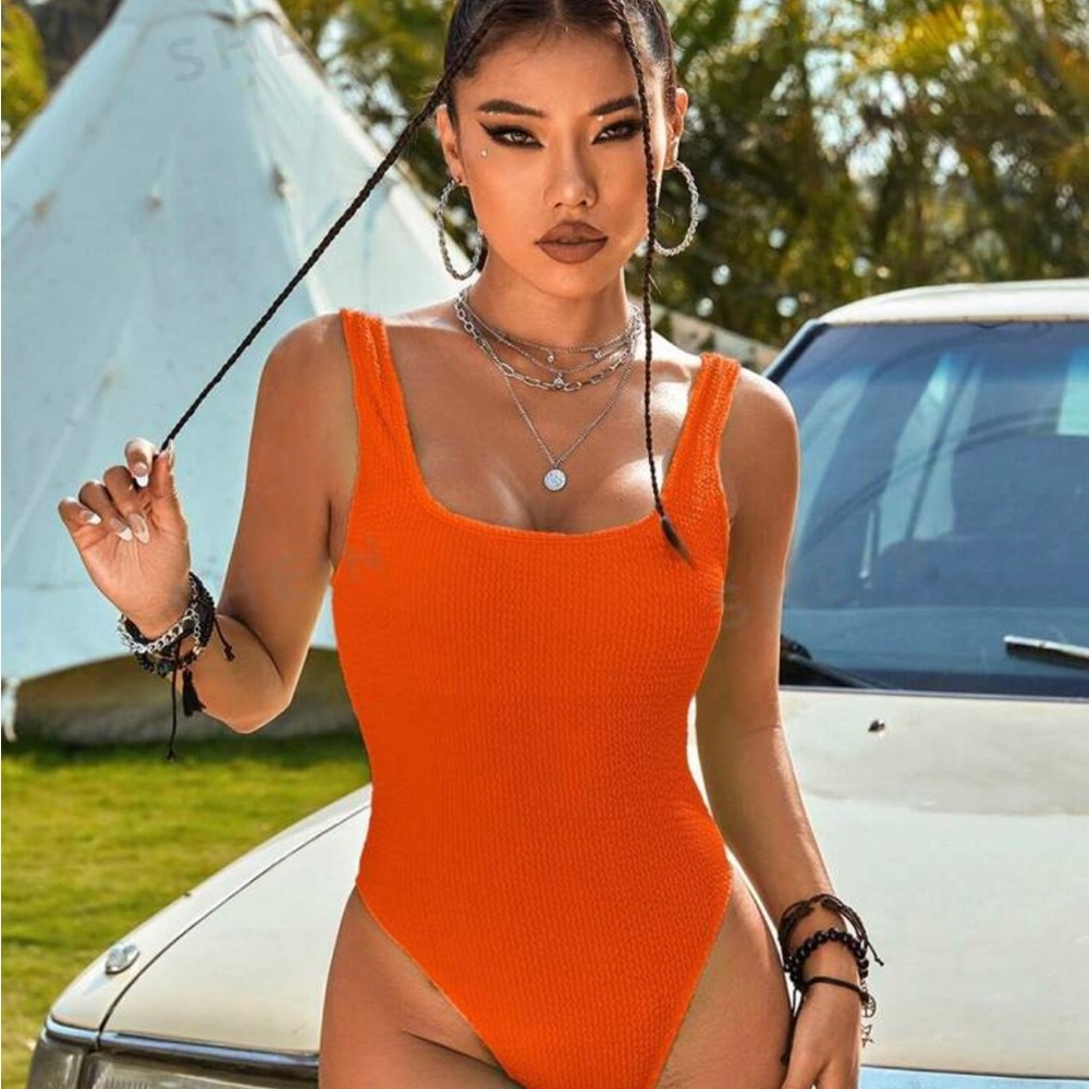 One piece high cut orange swimsuit small. New